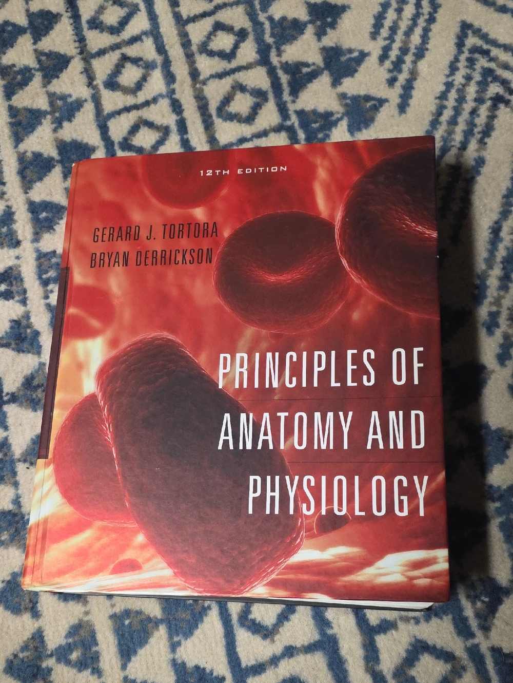 Principles of Anatomy and Physiology Textbook - Red Cover